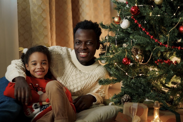 Father and Daughter by Christmas tree